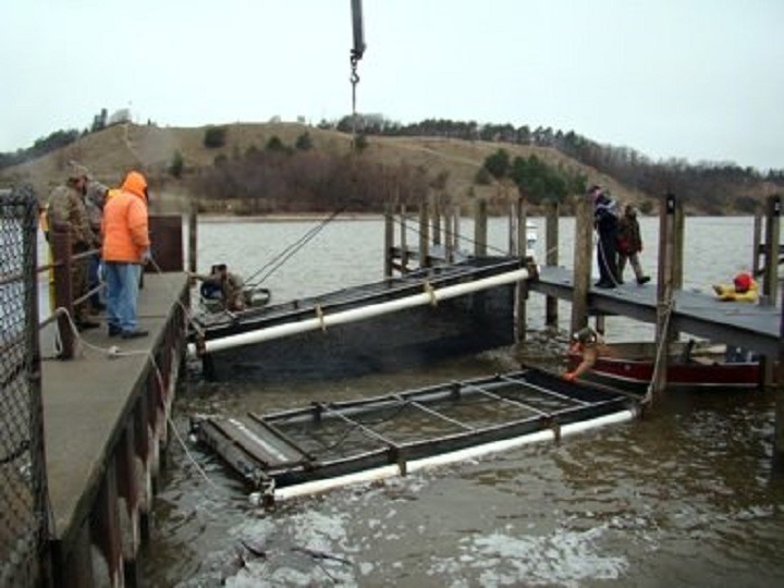 Men on a dock working with fish nets